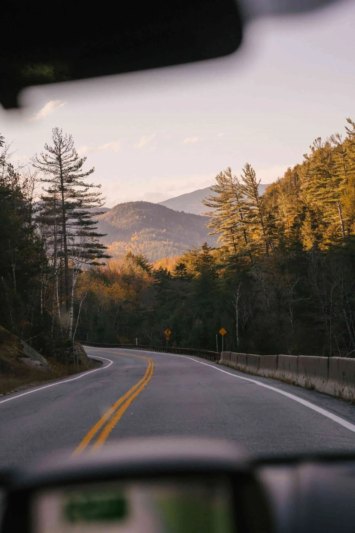 view of road from inside a car traveling through the mountains