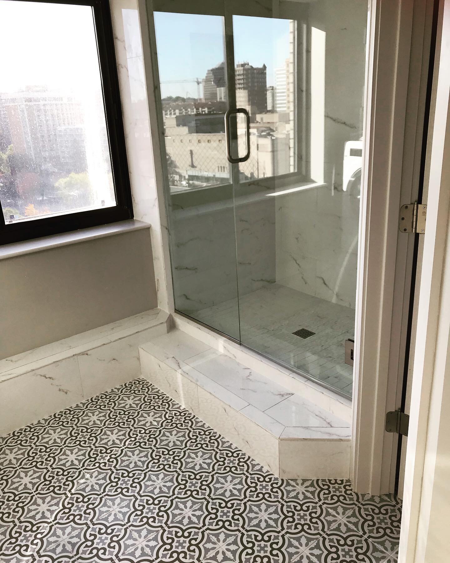 This penthouse unit on the Country Club Plaza provides beautiful views but when the client wanted to add a second bath to this concrete constructed condominium we needed to get creative with routing the plumbing. The step up shower was the solution.
