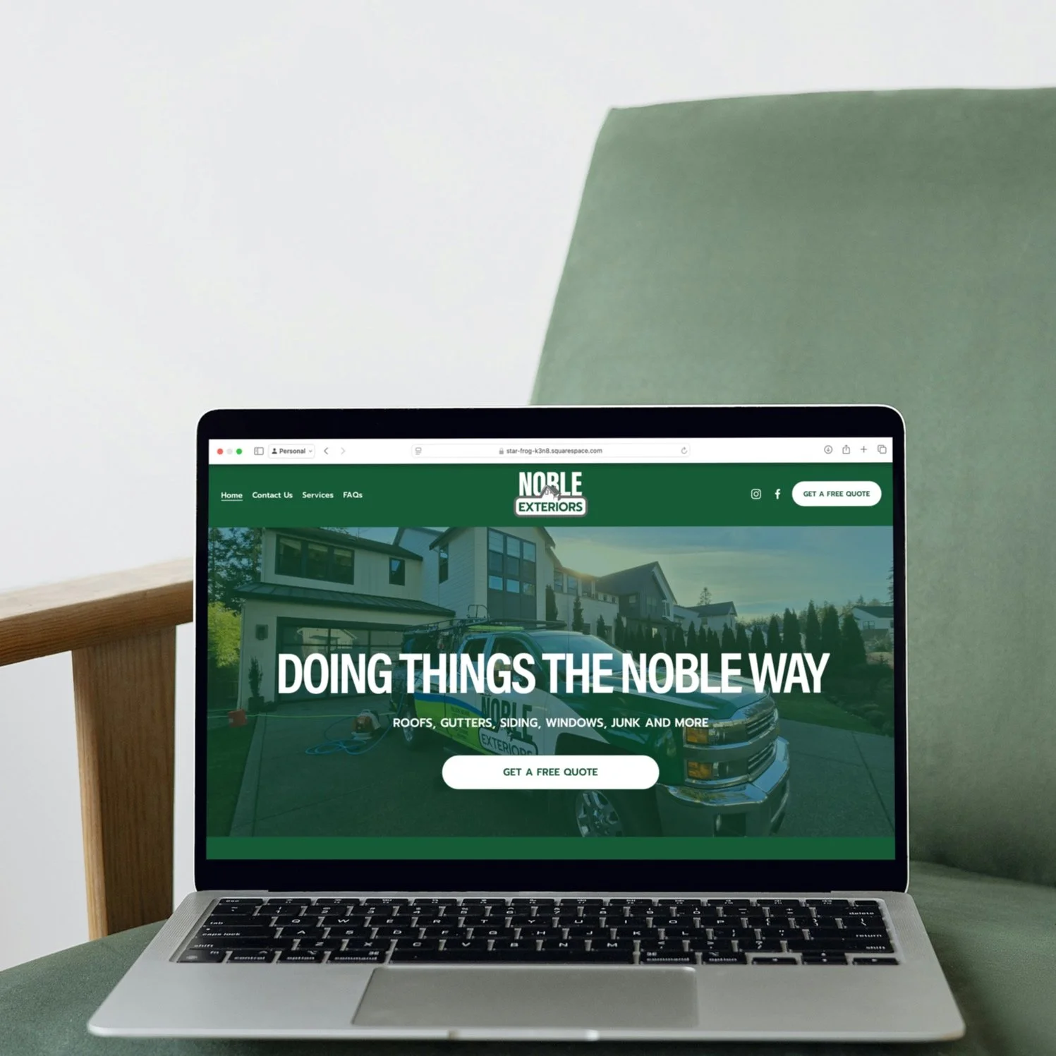 Laptop displaying a website for Noble Exteriors, a home exterior renovation service, showing a house, a Silverado truck, and buttons for a free quote and navigation menu.