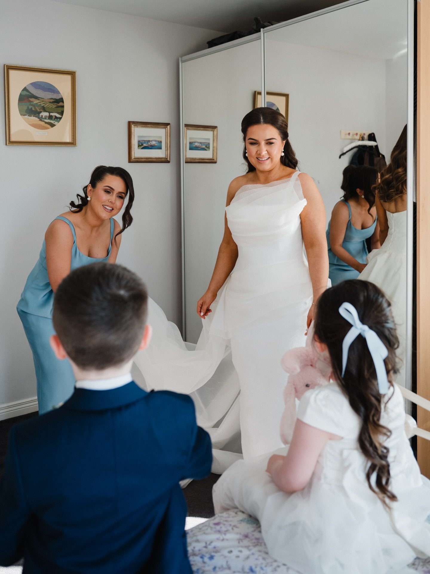 Bride Bronagh getting ready with her sister by her side, as their niece and nephew who were flowergirl &amp; pageboy watch on sweetly 🤍 Completely captivated by all the morning prep for the big day ahead. 
@bronaghquinn___ 
@theonebysineadcorcoran 
