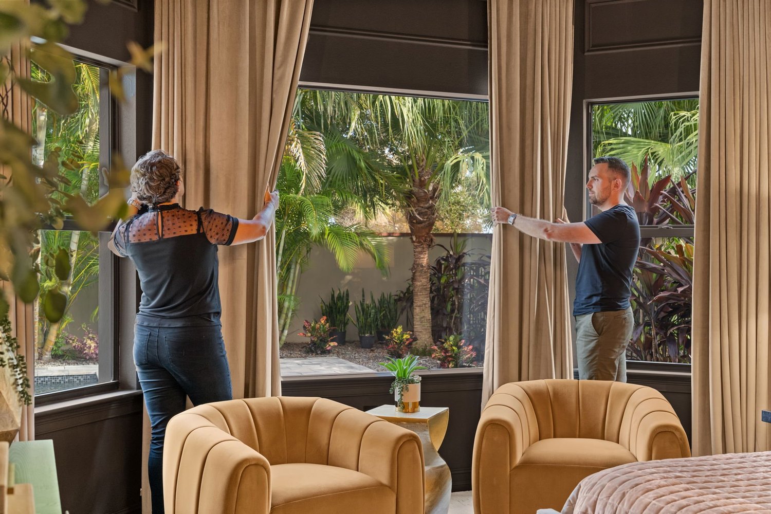 Thomas Plazanet and Suzi Percy, co-founders of LMD Interior Design Studio, sharing a high five