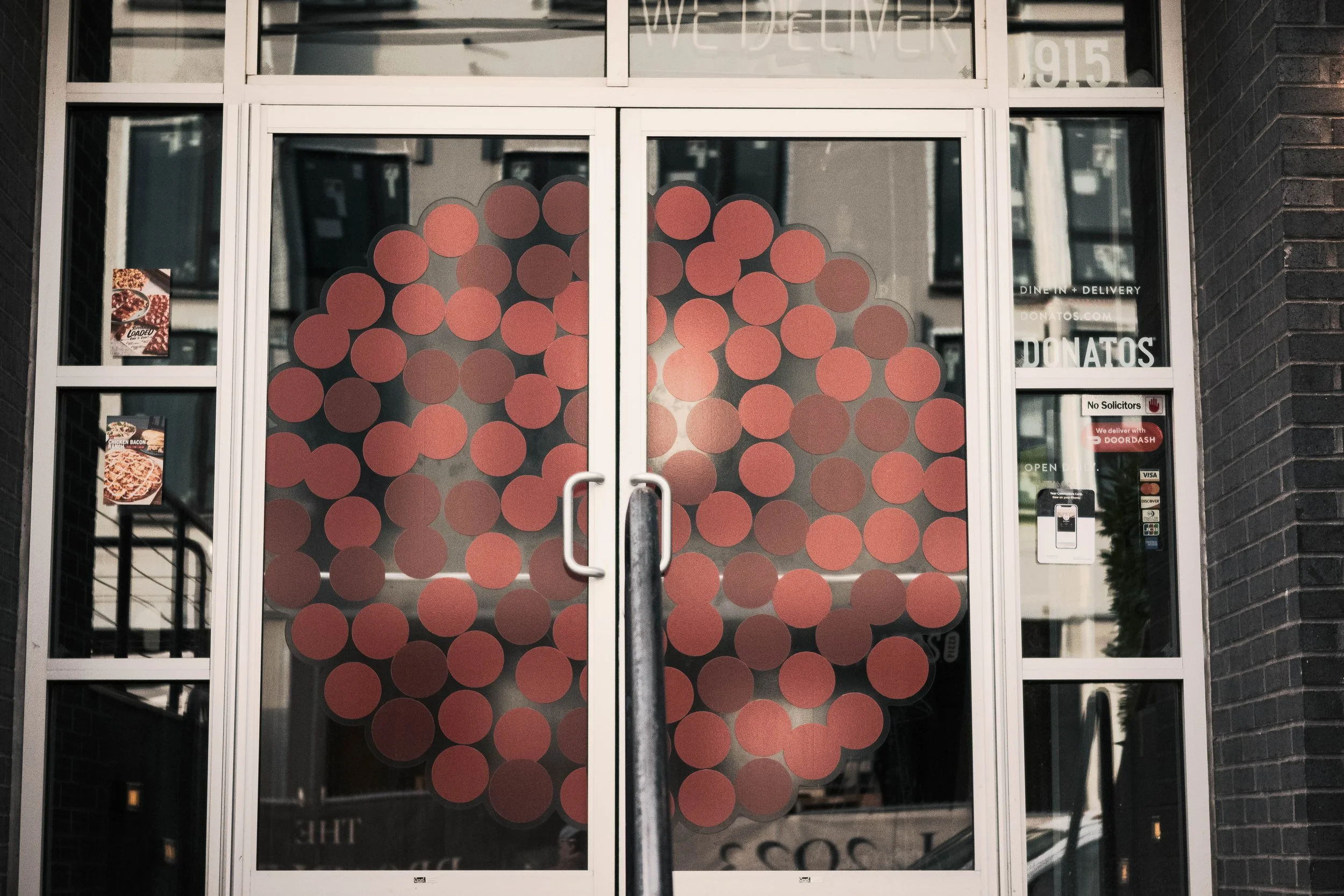 I dig how the doors on one of the many pizza joints in my neighborhood looks like a stylized pepperoni pie. 