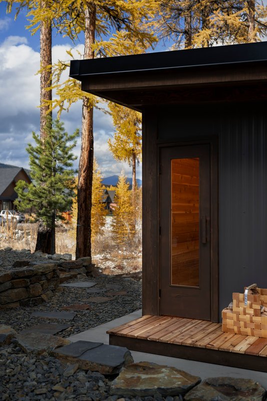 Mettä sauna entry with cedar deck and firewood basket, Kootenays, BC