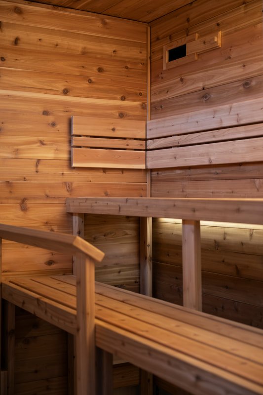 Cedar sauna interior with high benches, backrests and LED bench lighting