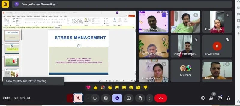 Screenshot of a virtual meeting with multiple participants discussing 'Stress Management' presentation, showing slides and participants' video feeds.