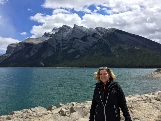 Carol Corso, the Pursuit director, standing in front of a mountain