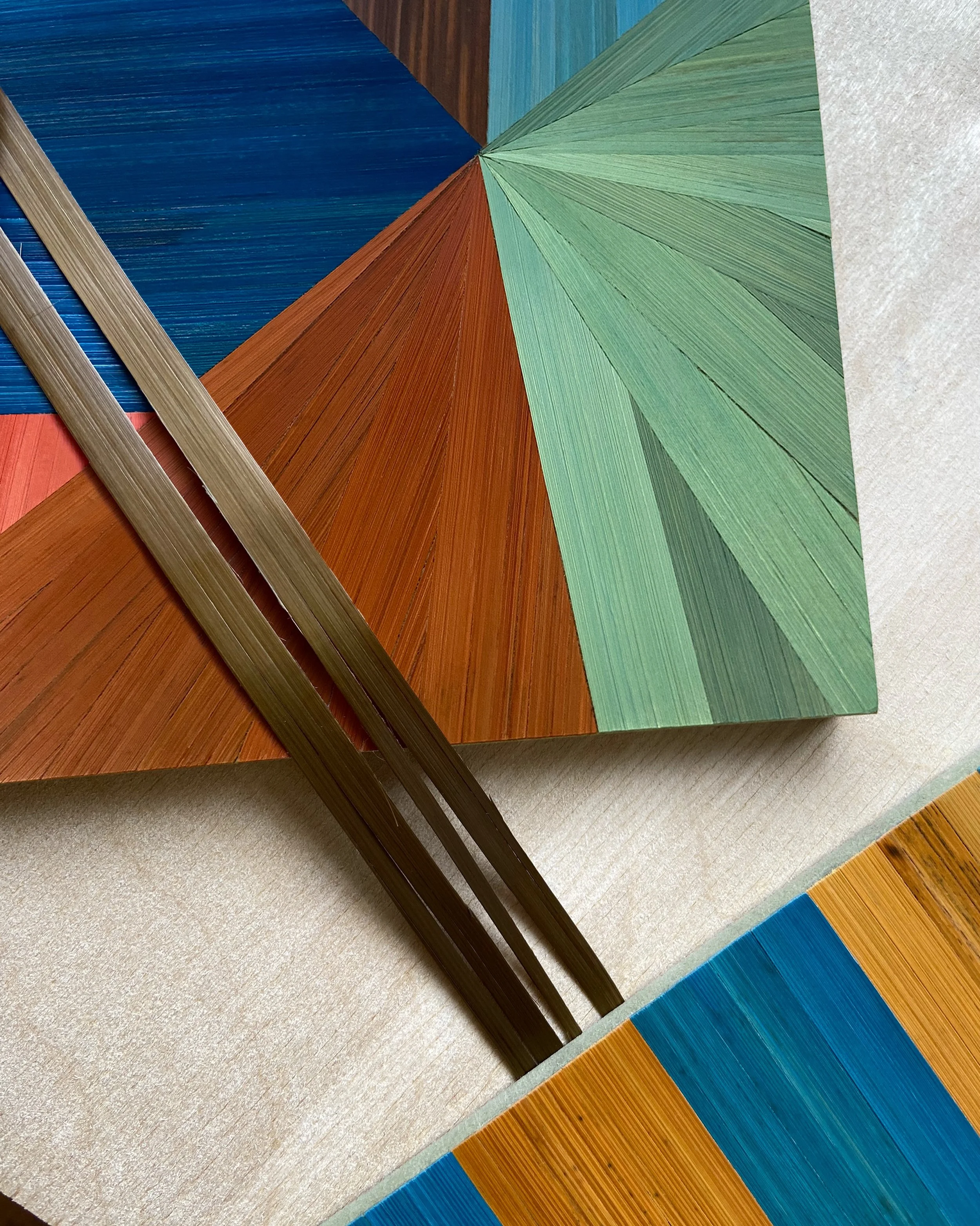 Straw marquetry samples in the studio. Playing with colour, pattern and direction.

Change the direction of the straw and you change how it catches the light. 
Same material. 
Completely different outcome.

So many possibilities. More designs in the 
