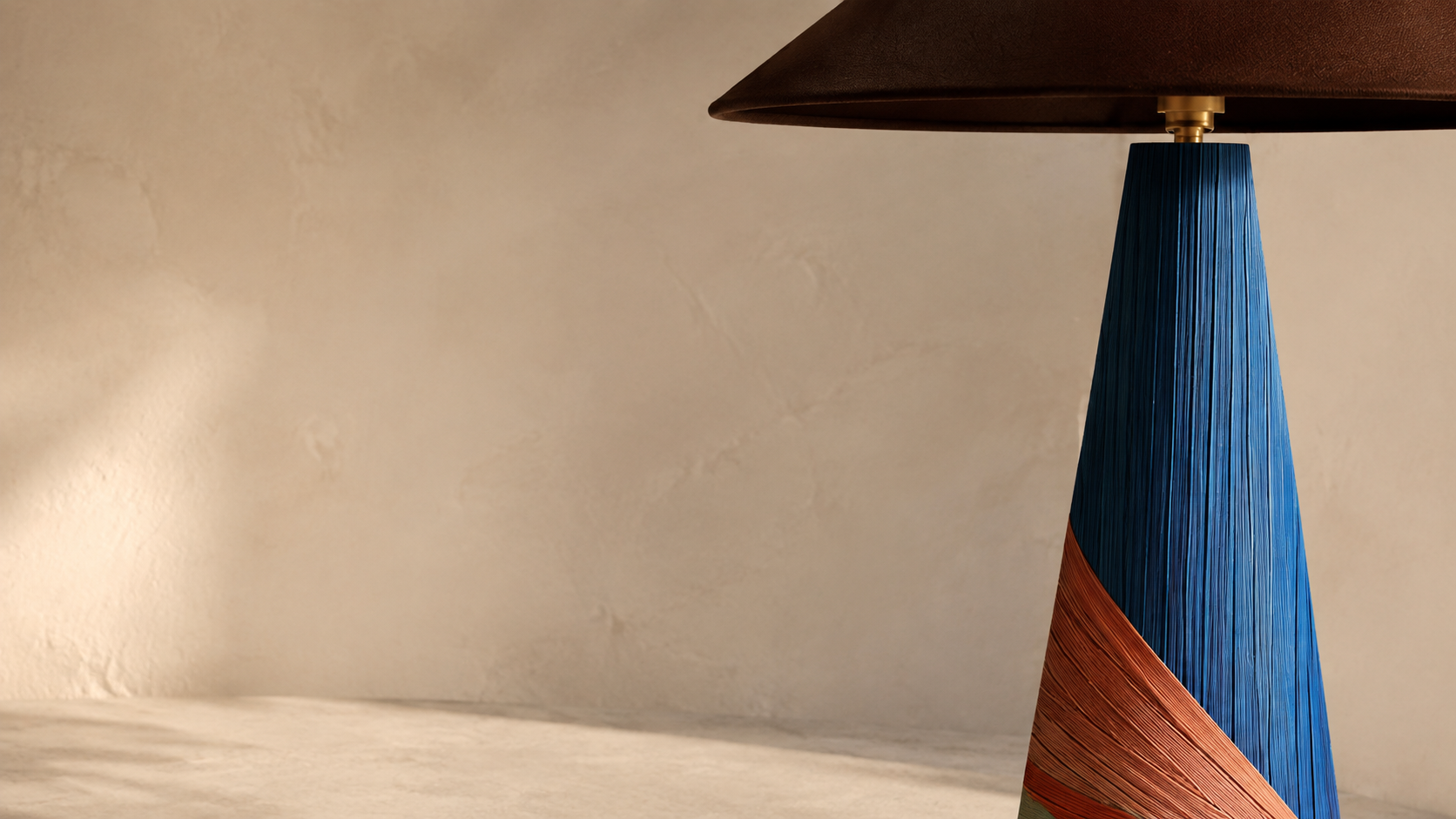 Close-up of a blue and rust-coloured straw-marquetry lamp handcrafted by Eleanor Nadimi.