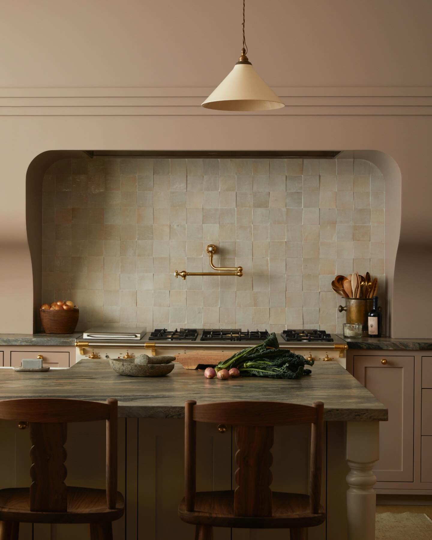 Pink, but make it architectural.

This kitchen flips the script with a dusty blush palette, grounded by sculpted wood, stone, and a softly curved surround that feels more carved-in than tacked-on. Understated, elevated, and quietly bold.

@ashleymont