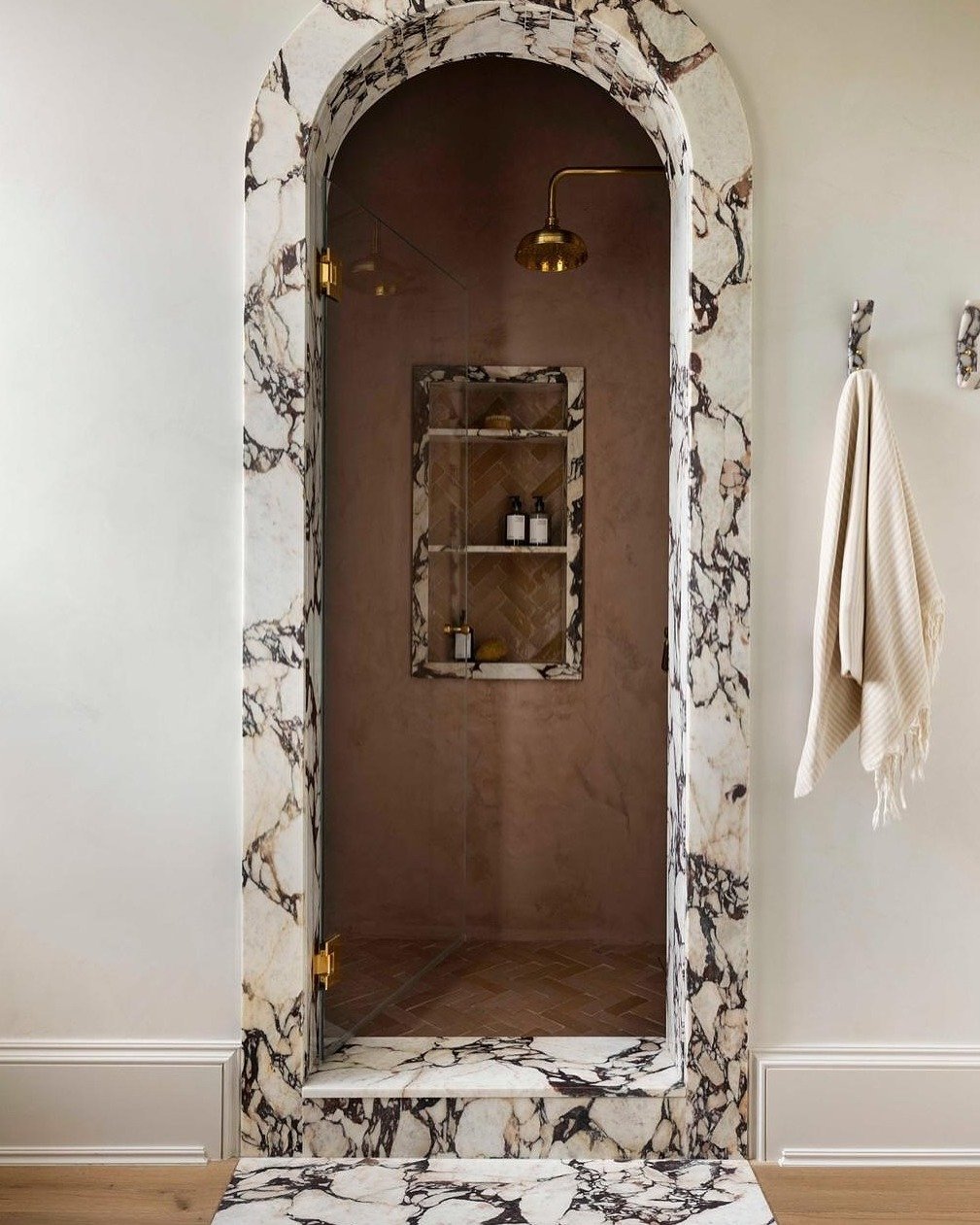 Proof that big impact doesn&rsquo;t have to mean big square footage.

A bold stone jamb around a simple shower opening? Total showstopper&mdash;and a smart way to splurge where it counts.

Let this be your reminder: a single slab, expertly placed, ca
