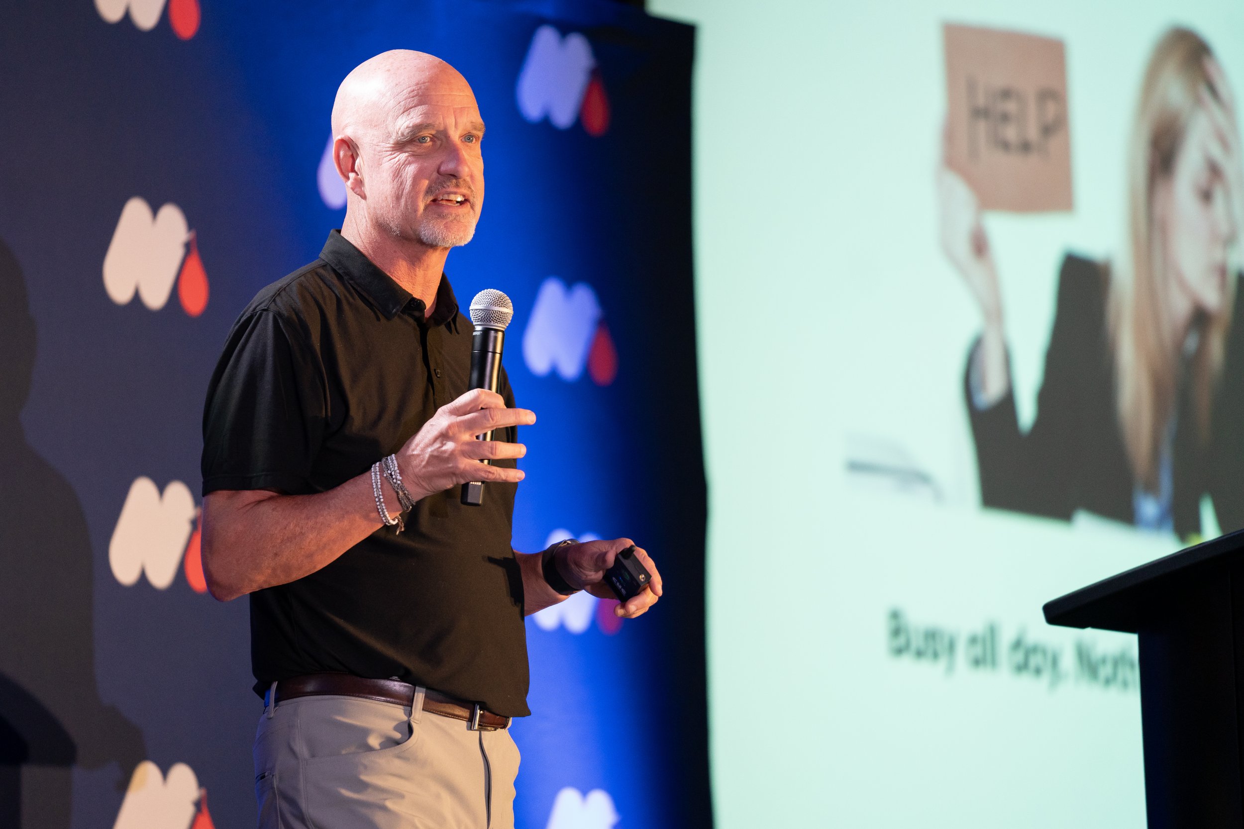 John R. Kormanik giving a keynote presentation at a leadership conference on shifting from lawyer-mode to leading like a CEO.