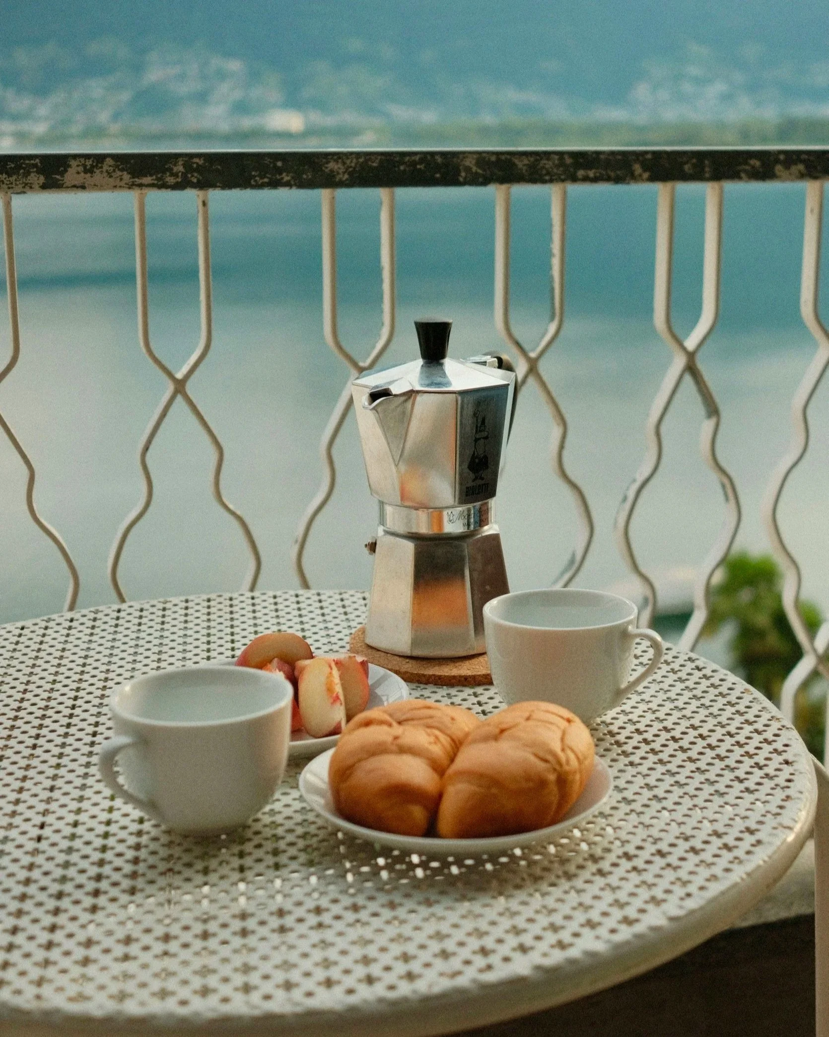 Coffee and pastry with a scenic view, representing the annual luxury retreat included for John R. Kormanik's 1:1 coaching clients and Law Leaders Syndicate™ members.