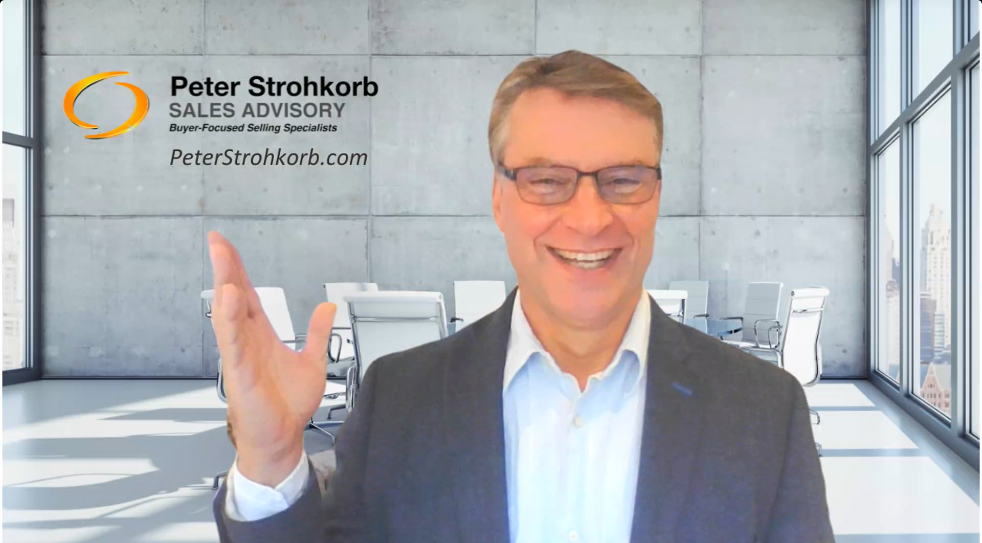 A man in a business suit and glasses smiling and waving in a modern conference room with large windows, white chairs, and a cityscape view in the background. The wall behind him has the text 'Peter Strohkorb SALES ADVISORY Buyer-Focused Selling Specialists PeterStrohkorb.com' along with an orange and black logo.