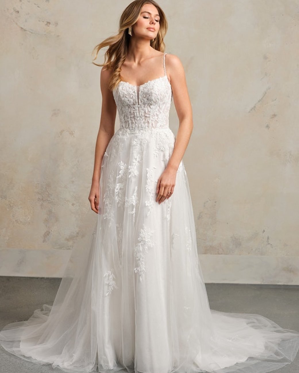 Our newest gown, Catherine, is the sparkly floral a-line you&rsquo;ve been waiting for! She is delicate, soft, and oh-so romantic✨ Beaded spaghetti straps lead into a soft scoop neckline and sheer-organza lined bodice. The skirt is decorated in beade