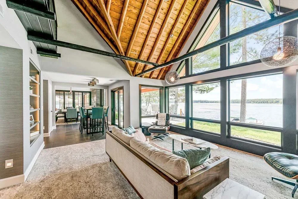 A bright, open living room of a custom home with a view of Lake Norman.