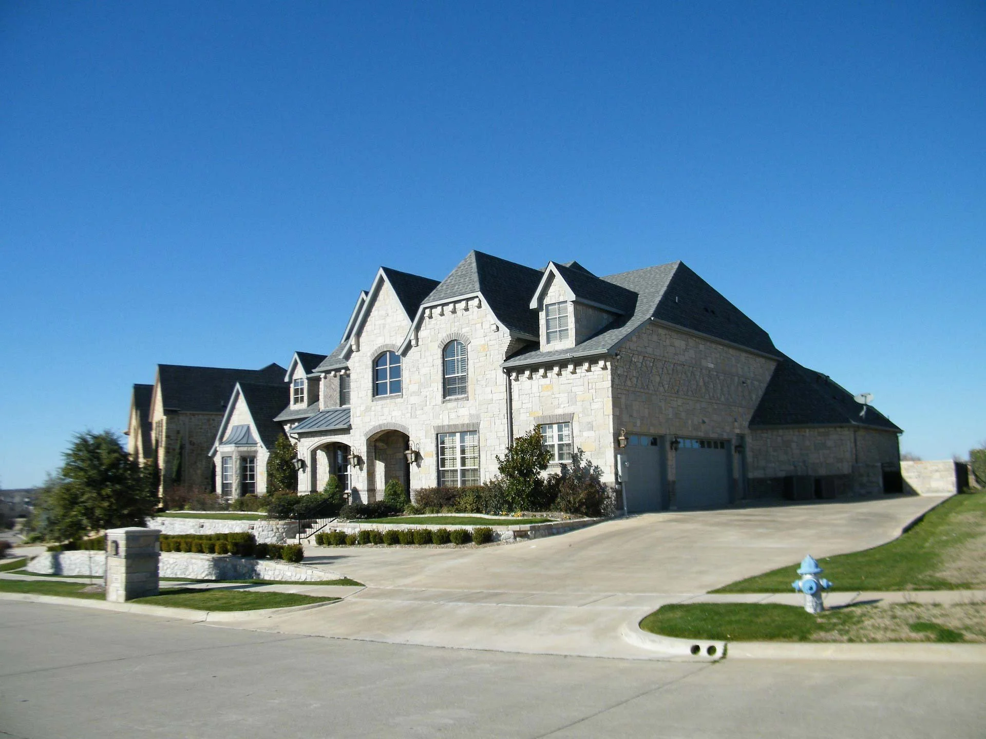 A traditional-style, luxury stone home on a cul-de-sac.
