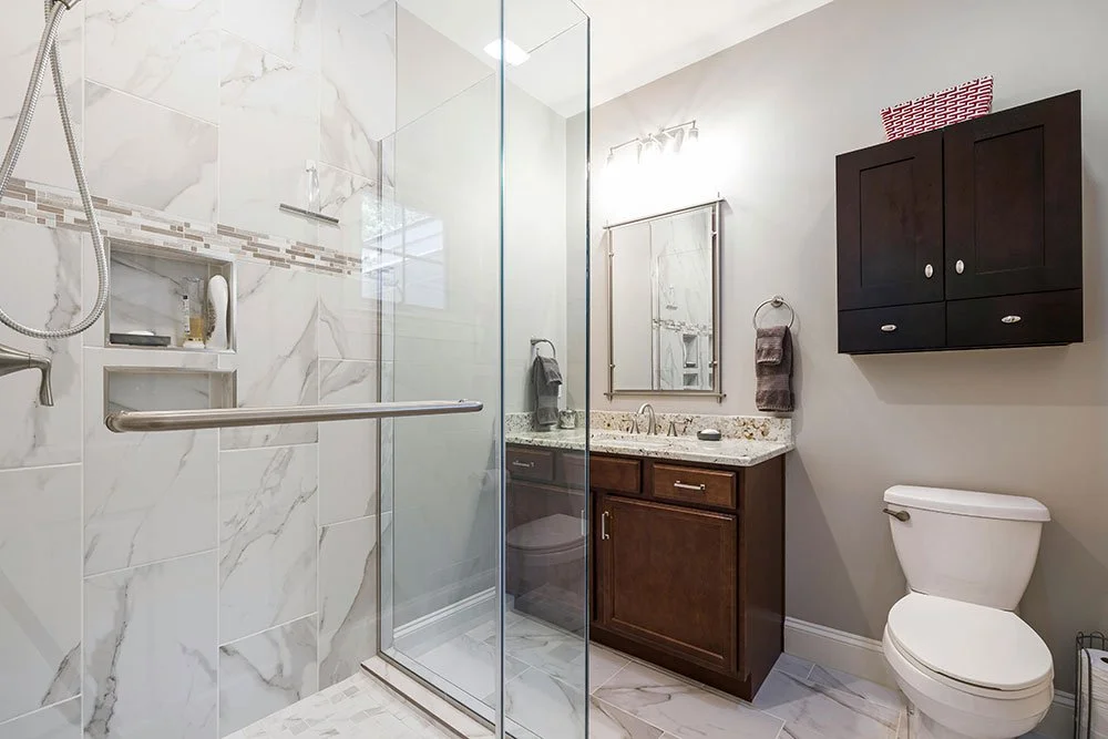 Spacious glass shower with luxury tiling in a fully remodeled bathroom.