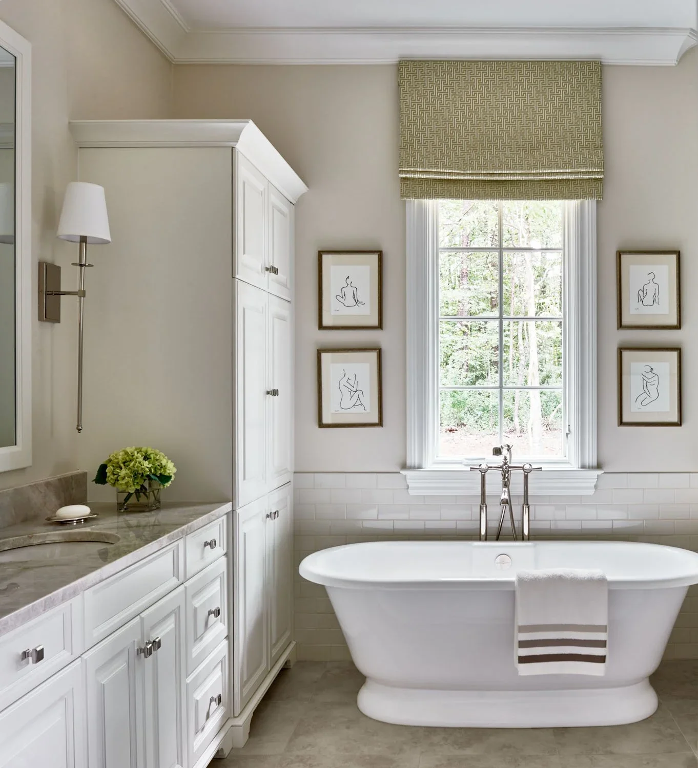 Freestanding white bathtub in a luxury bathroom designed by trusted home builders in Charlotte.