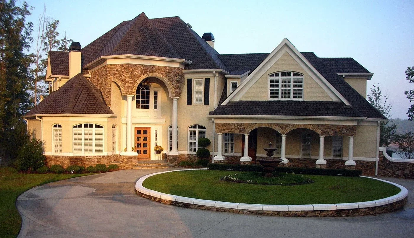 Luxurious brick home with a circular driveway.