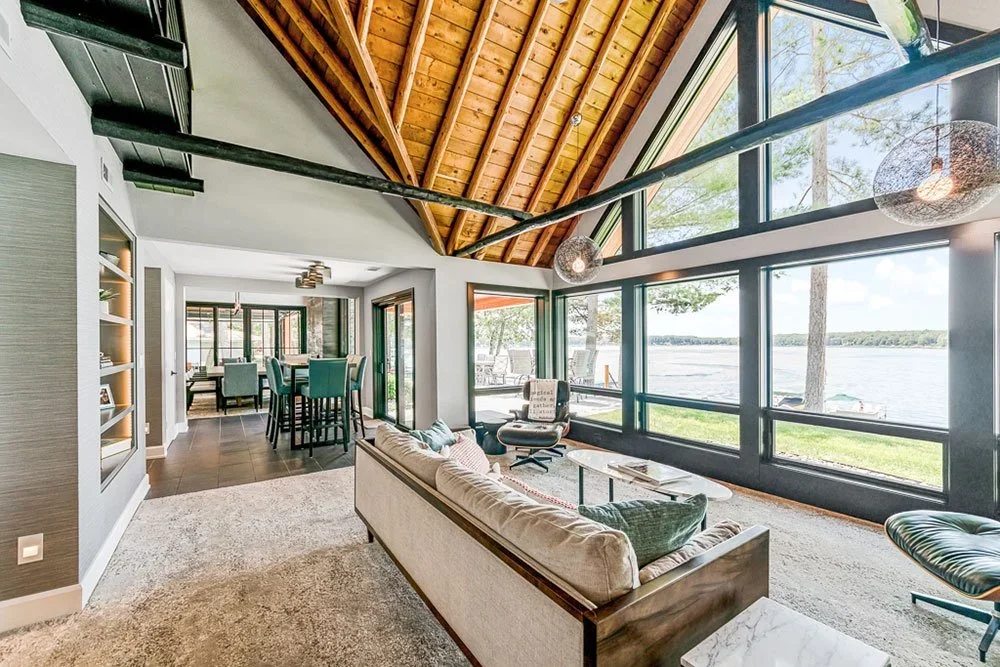 Interior of a custom lakefront home near Lake Norman featuring vaulted wood ceilings and floor-to-ceiling windows built by Lakeview Building Group.