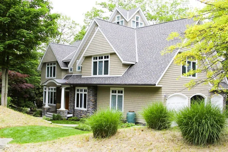 Exterior of a luxury custom home near Lake Norman featuring stonework accents.