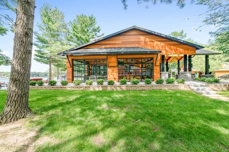 Lakefront custom home with wood exterior and large windows built by Lakeview Building Group near Lake Norman in North Carolina.