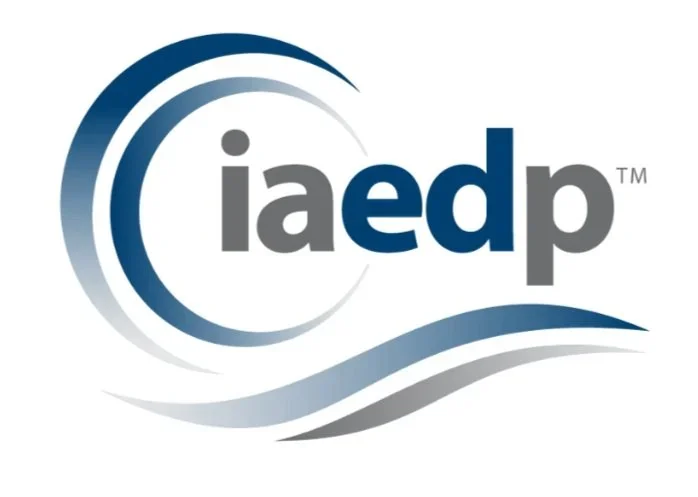 Logo with the text 'iaedp' surrounded by curved lines in shades of blue and gray.