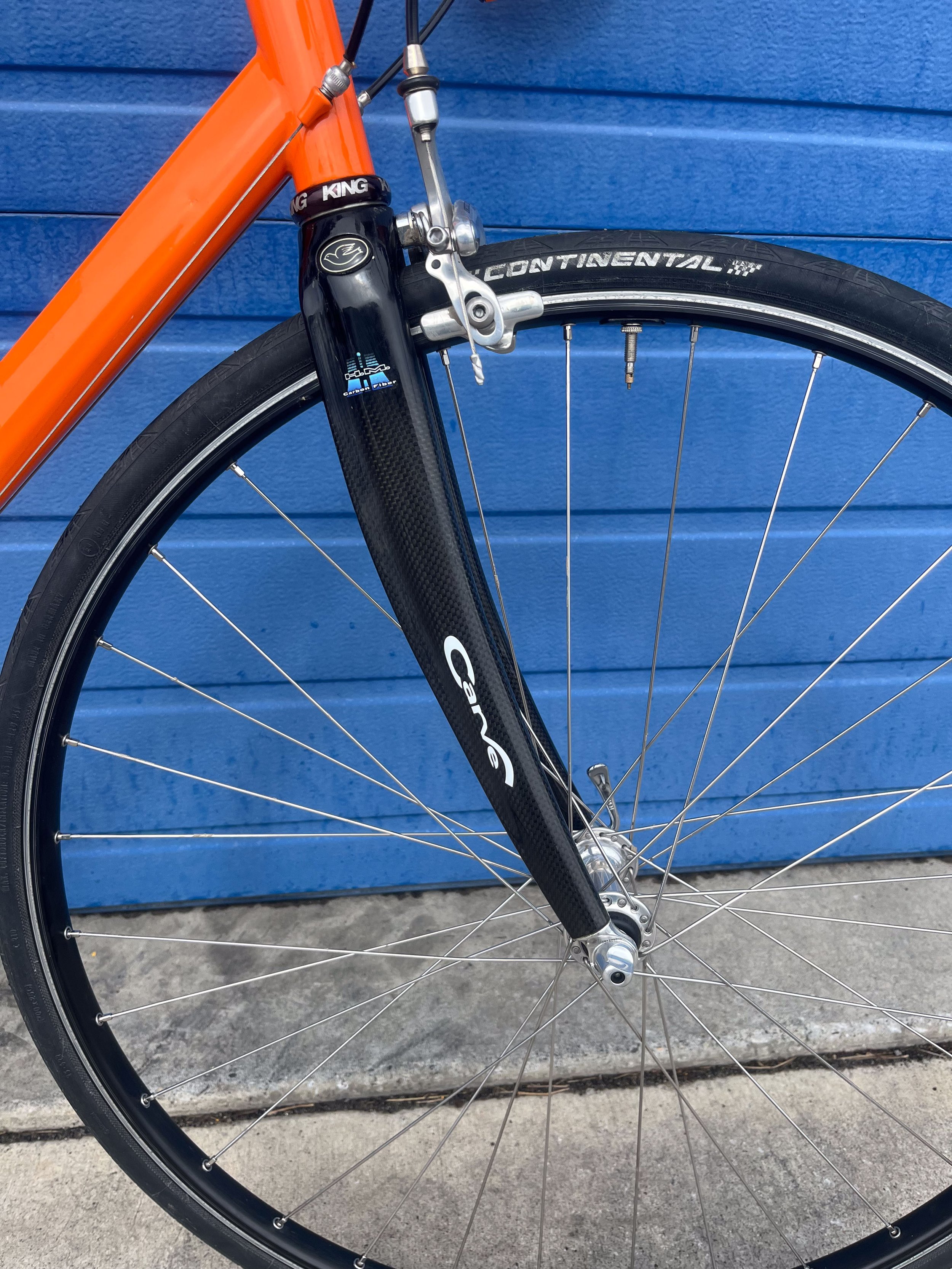 Photo of a custom made steel orange Strong road bike for sale.