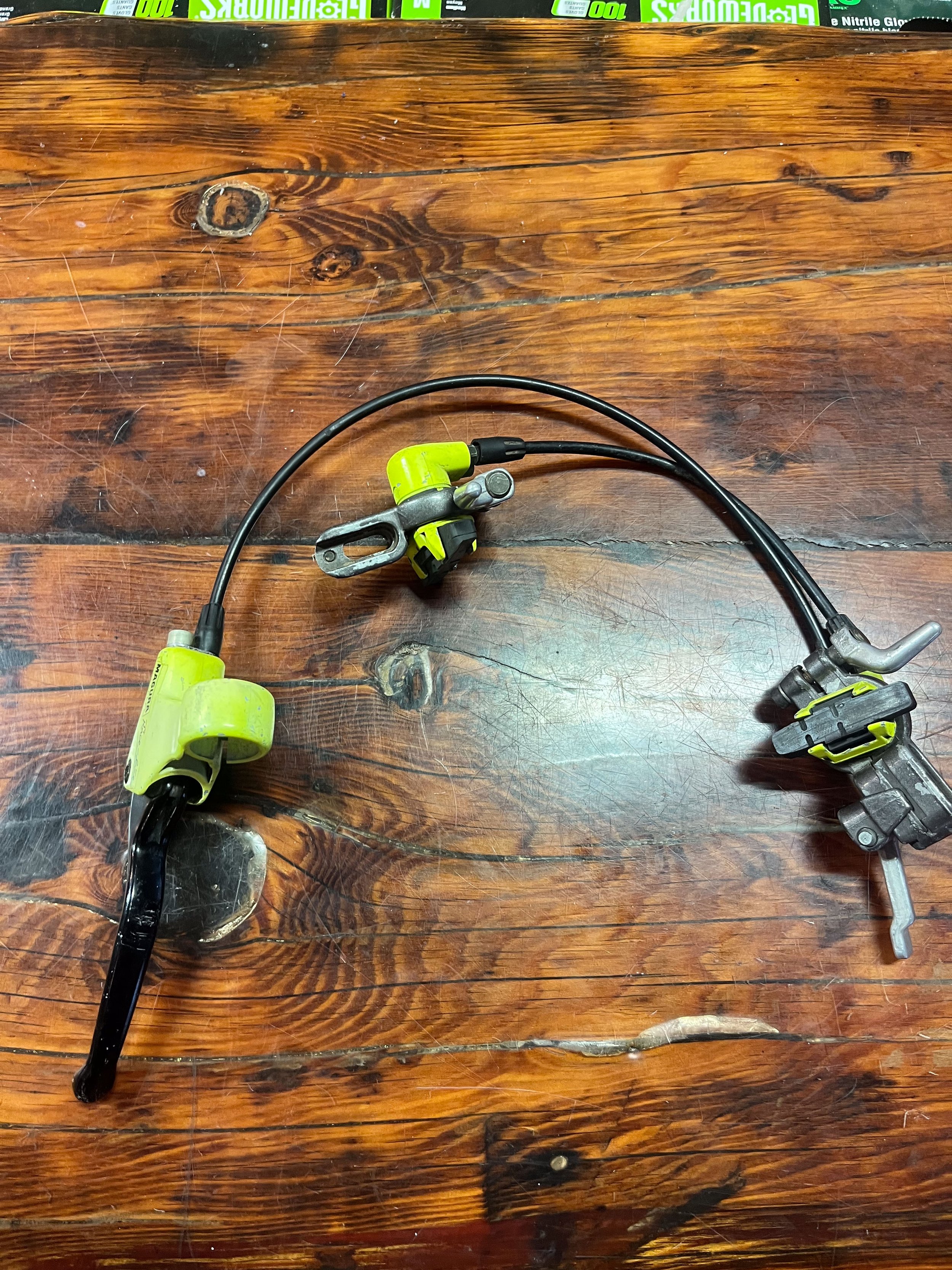 Photo of a pair of Magura Race-Line Evolution hydraulic rim brakes in neon yellow and black for sale.