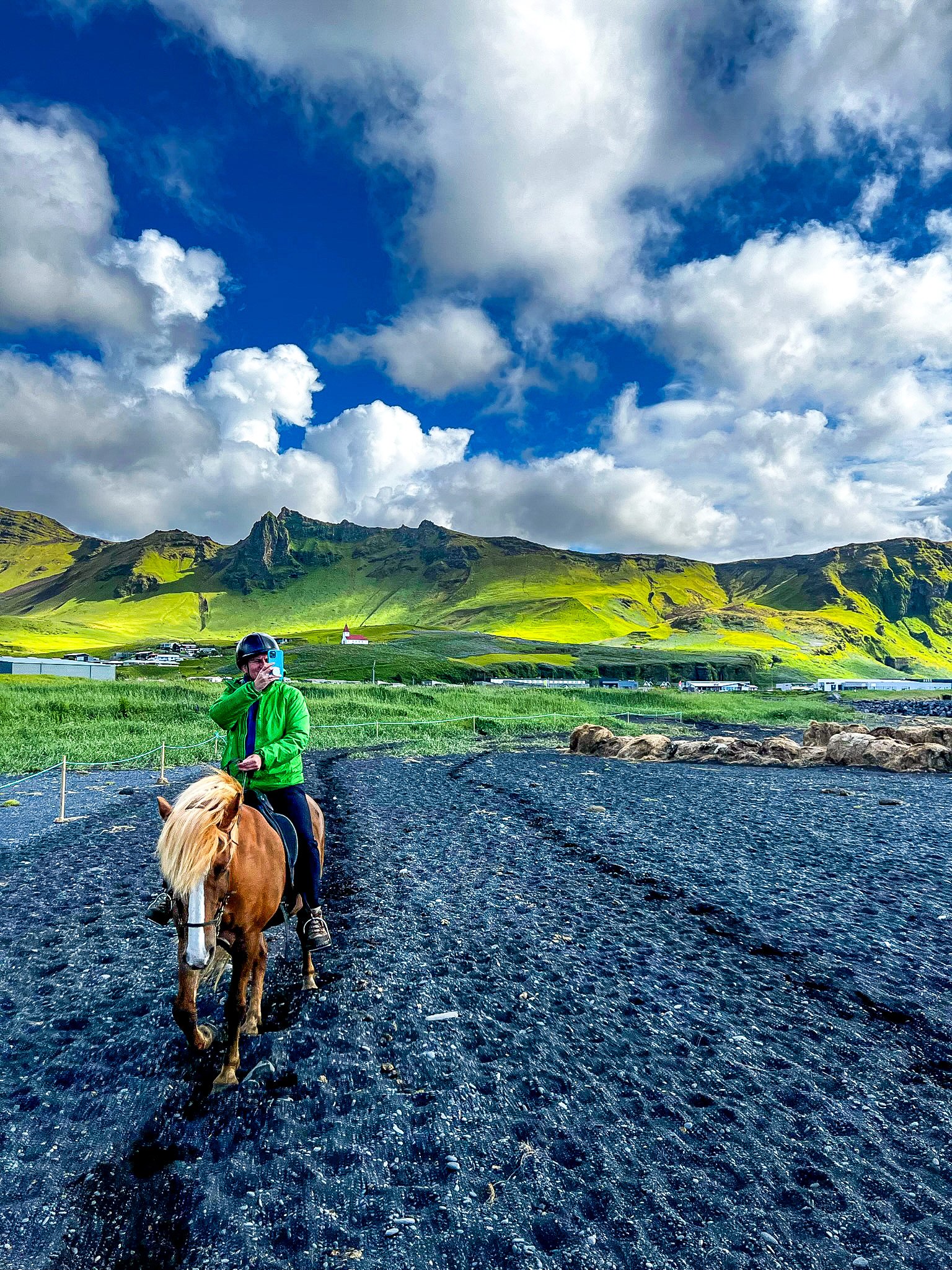 Kitty on horseback on a black sand beach in southern Iceland, near Vík.