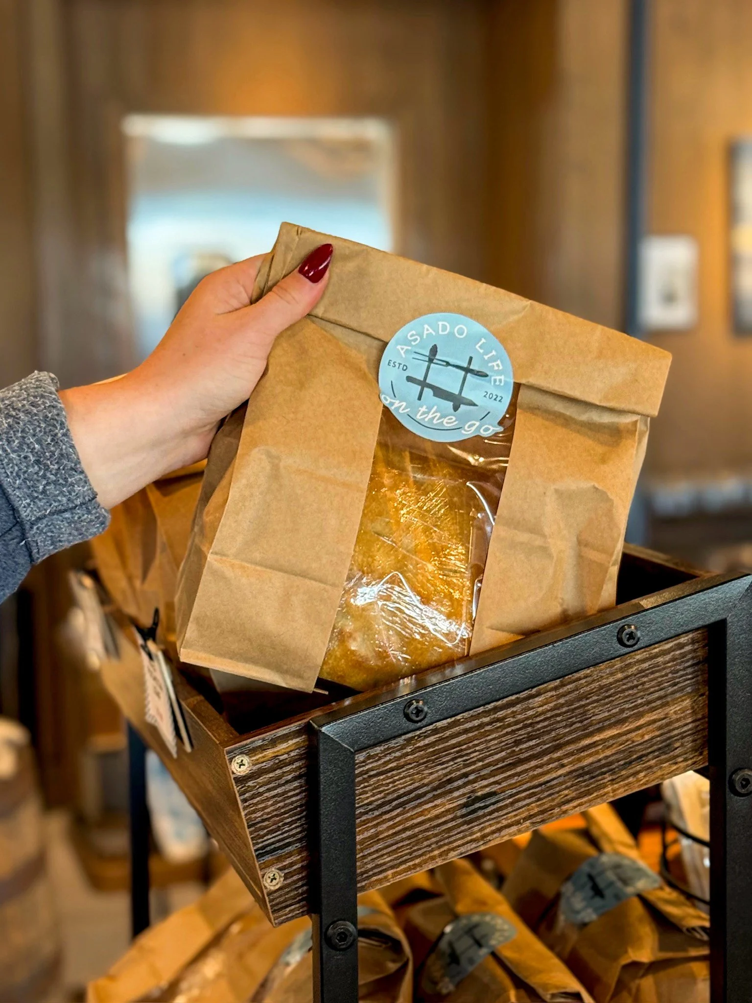 Guest grabbing Freshly baked housemade focaccia available in the Asado Life market.