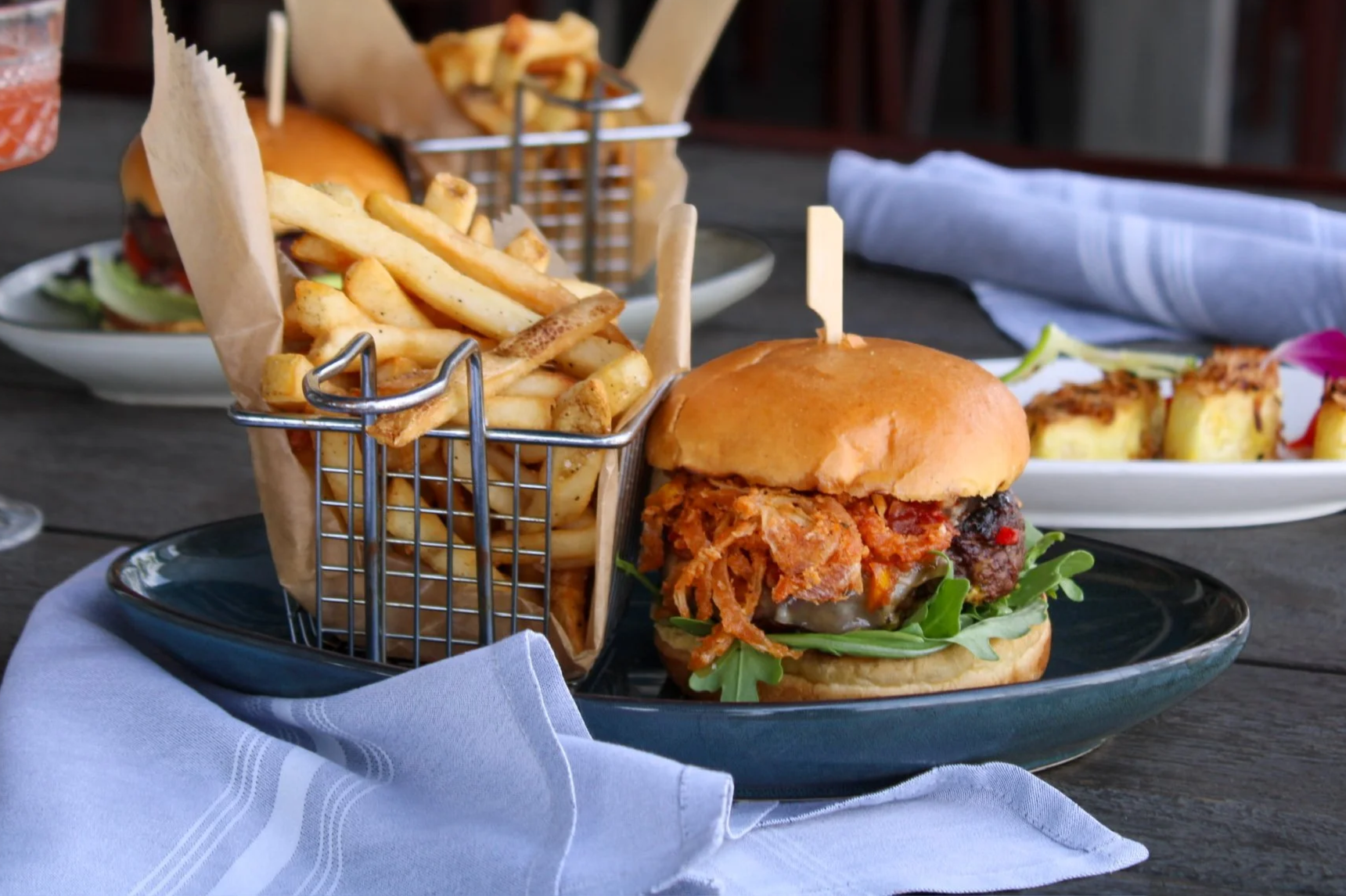 Gaucho burger plated with a basket of fries