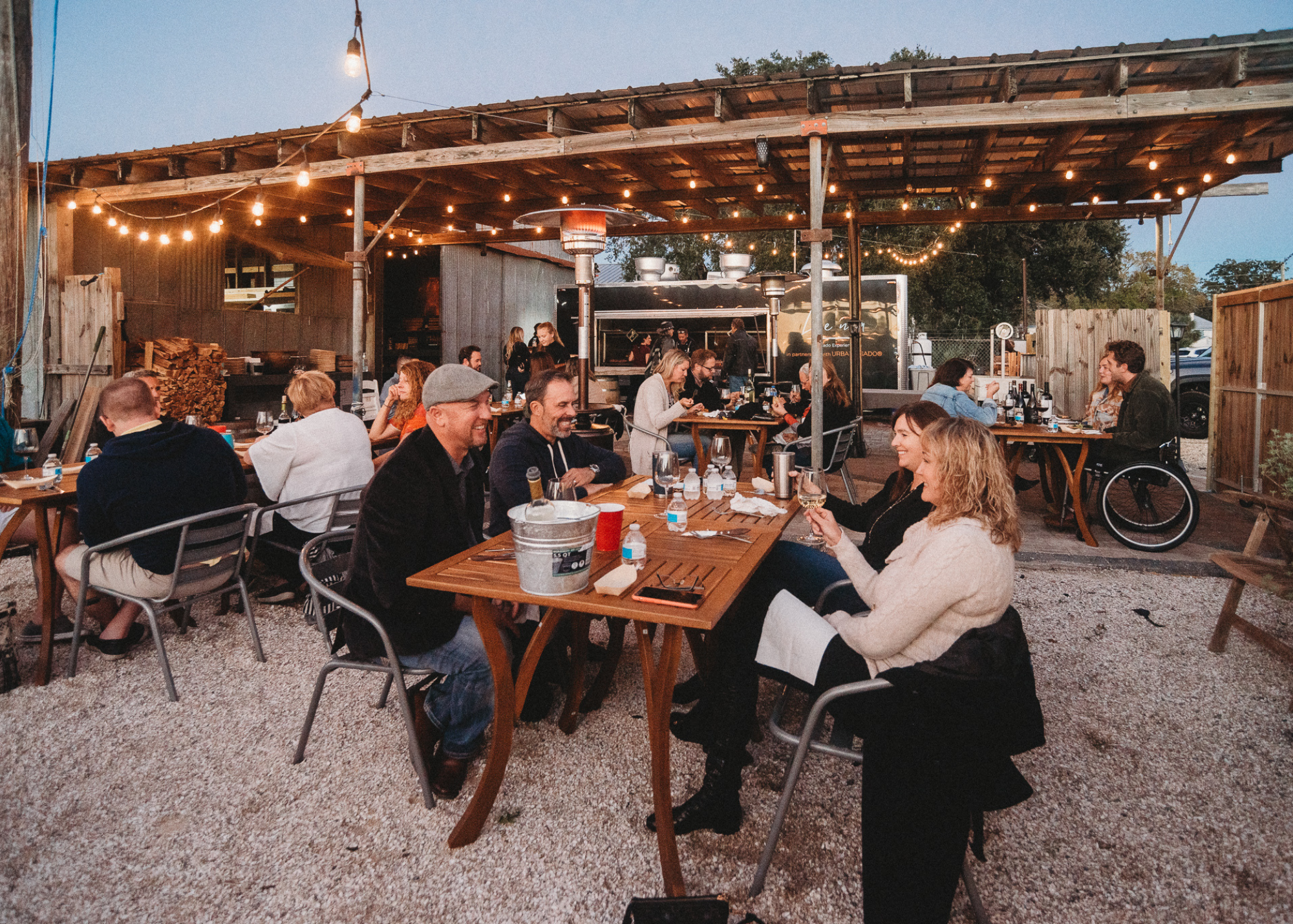 Guests enjoying a meal together at Urban Asado, a grill fabrication studio and event space.