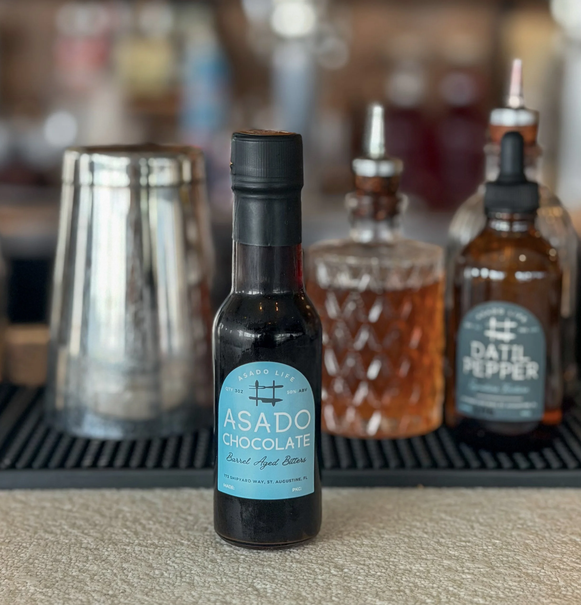 Asado Life’s housemade chocolate bitters, crafted in-house with rich, bittersweet depth.