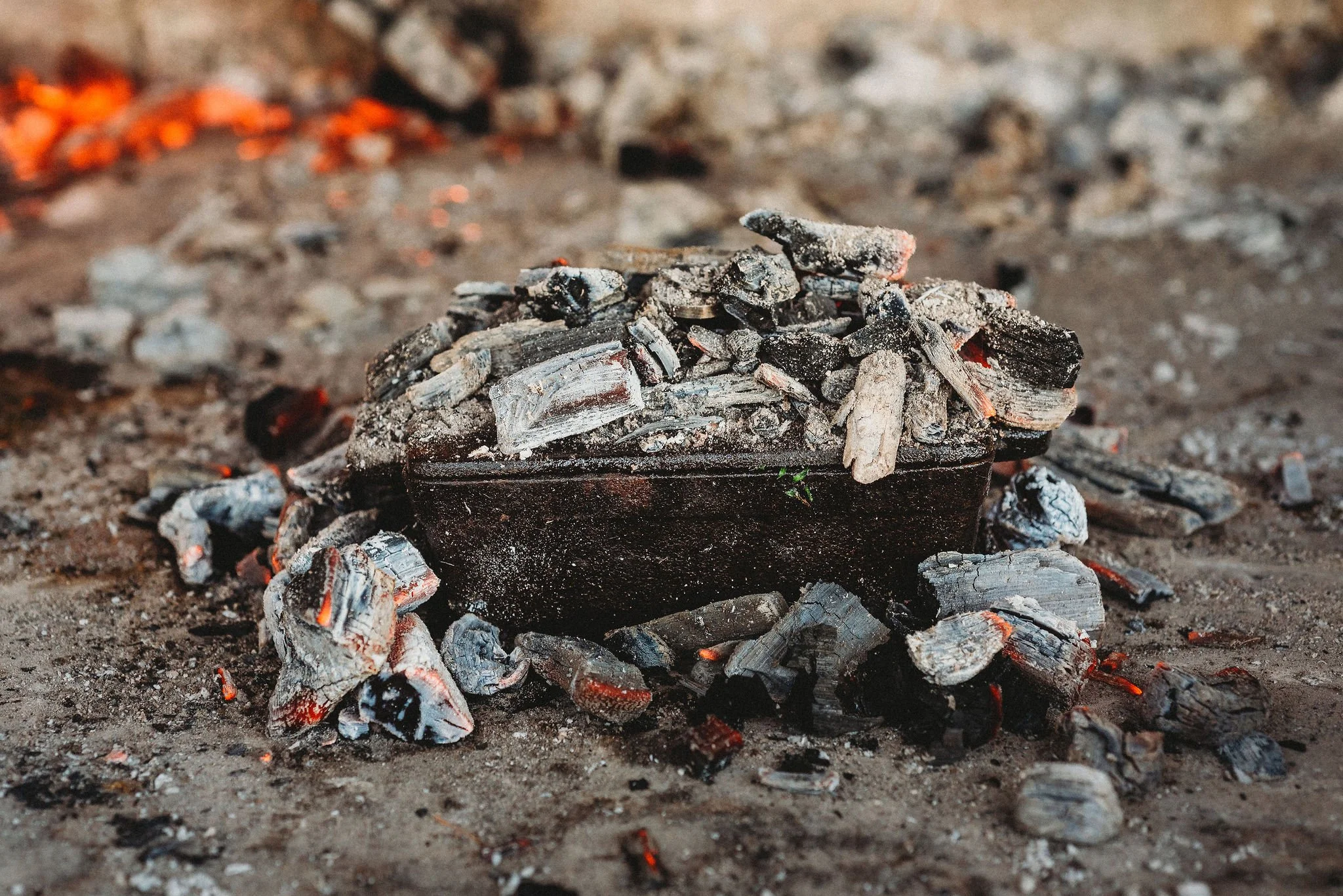 Sealed cast iron is buried in burning coals