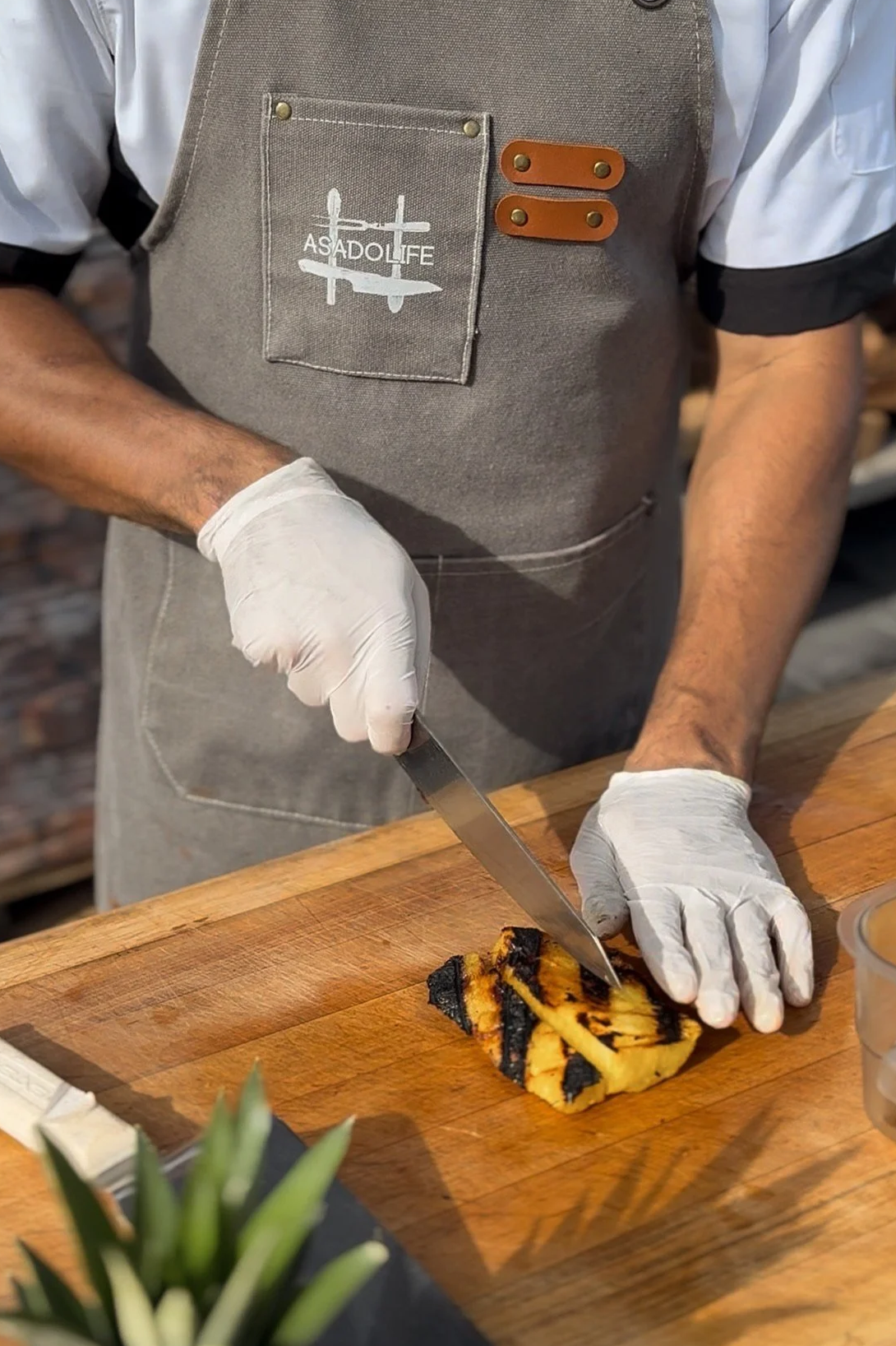 Chef slicing grilled pineapple