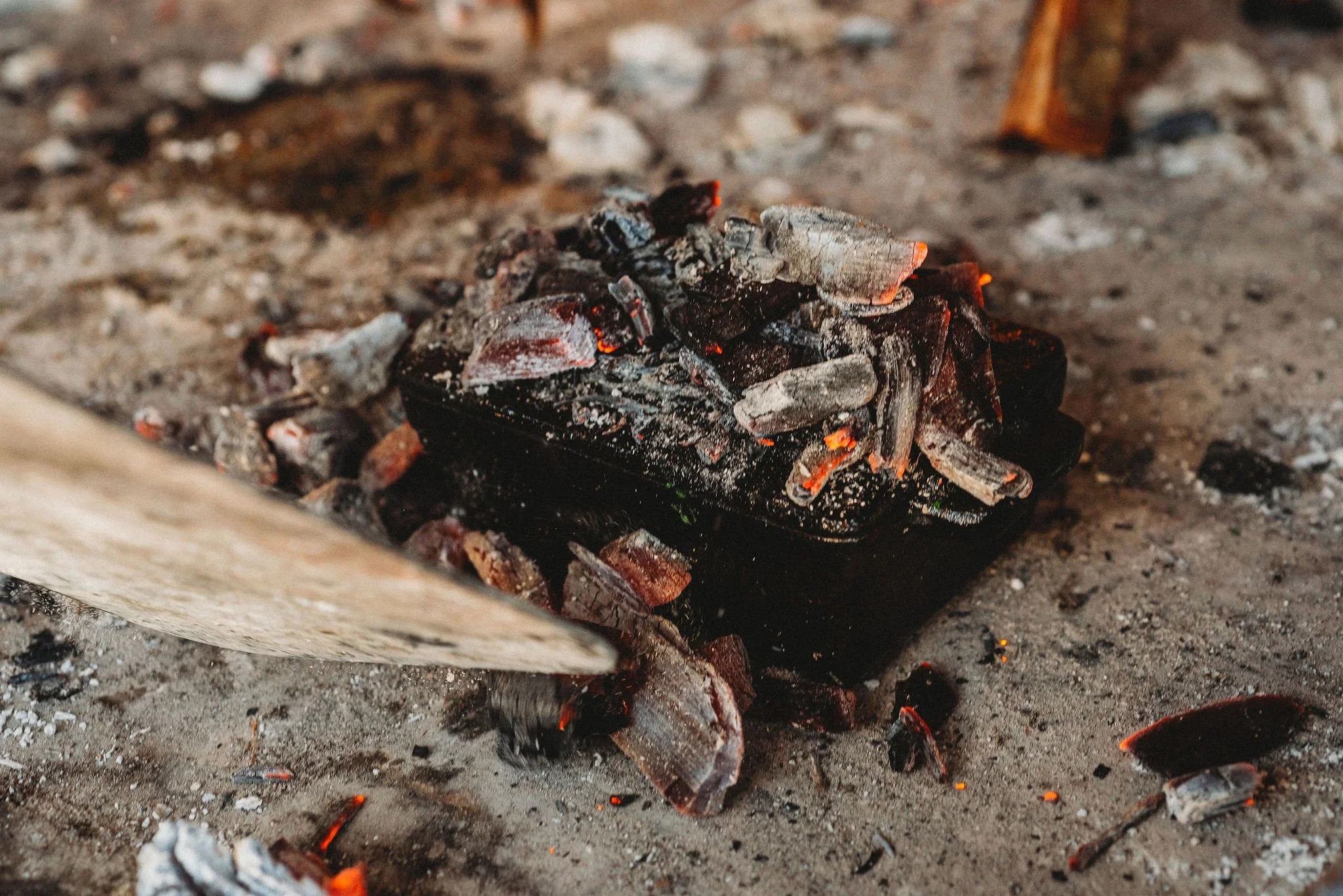 Coal is being shoveled on a sealed cast iron