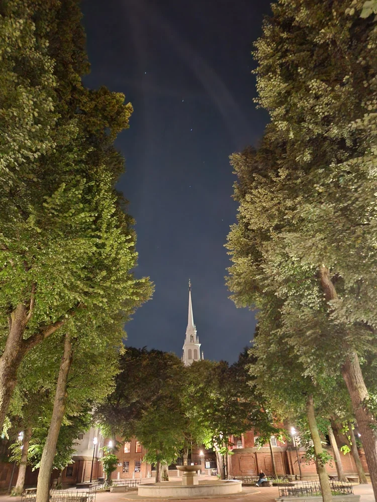 Paul Revere Mall at night with trees and warm lighting
