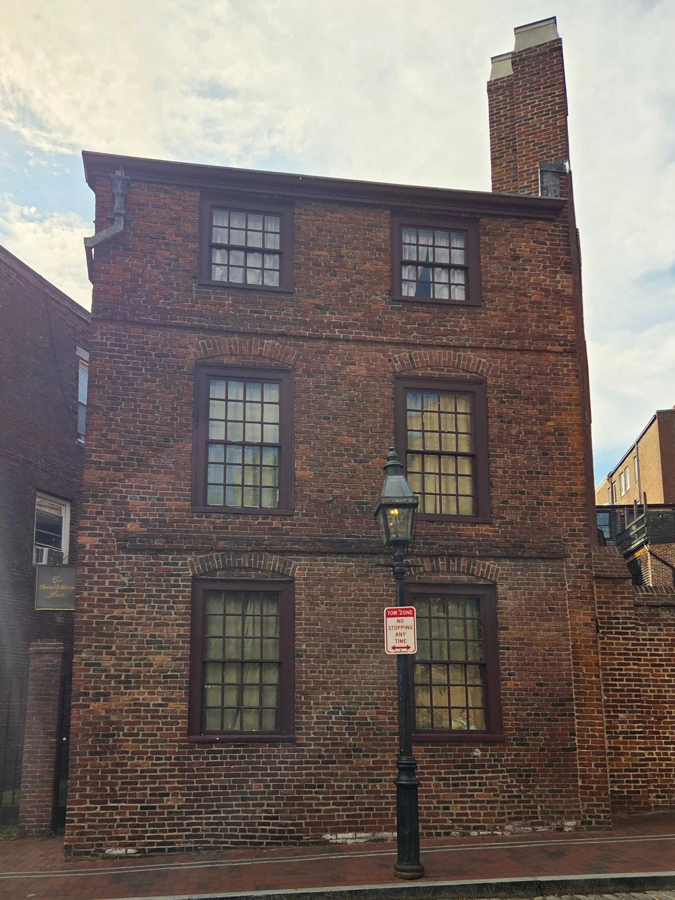 narrow three-story brick building