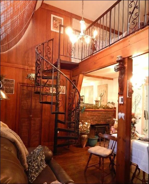 Interior of the tiny home showing the compact living space with fireplace