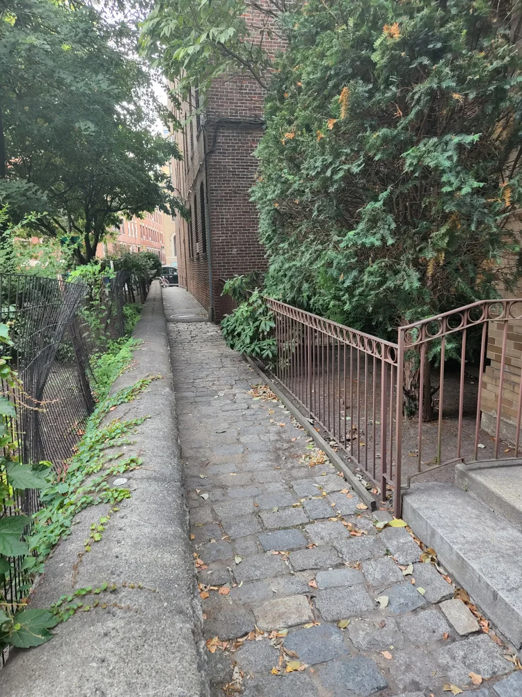Narrow cobblestone passage of Greenough Lane in Boston's North End