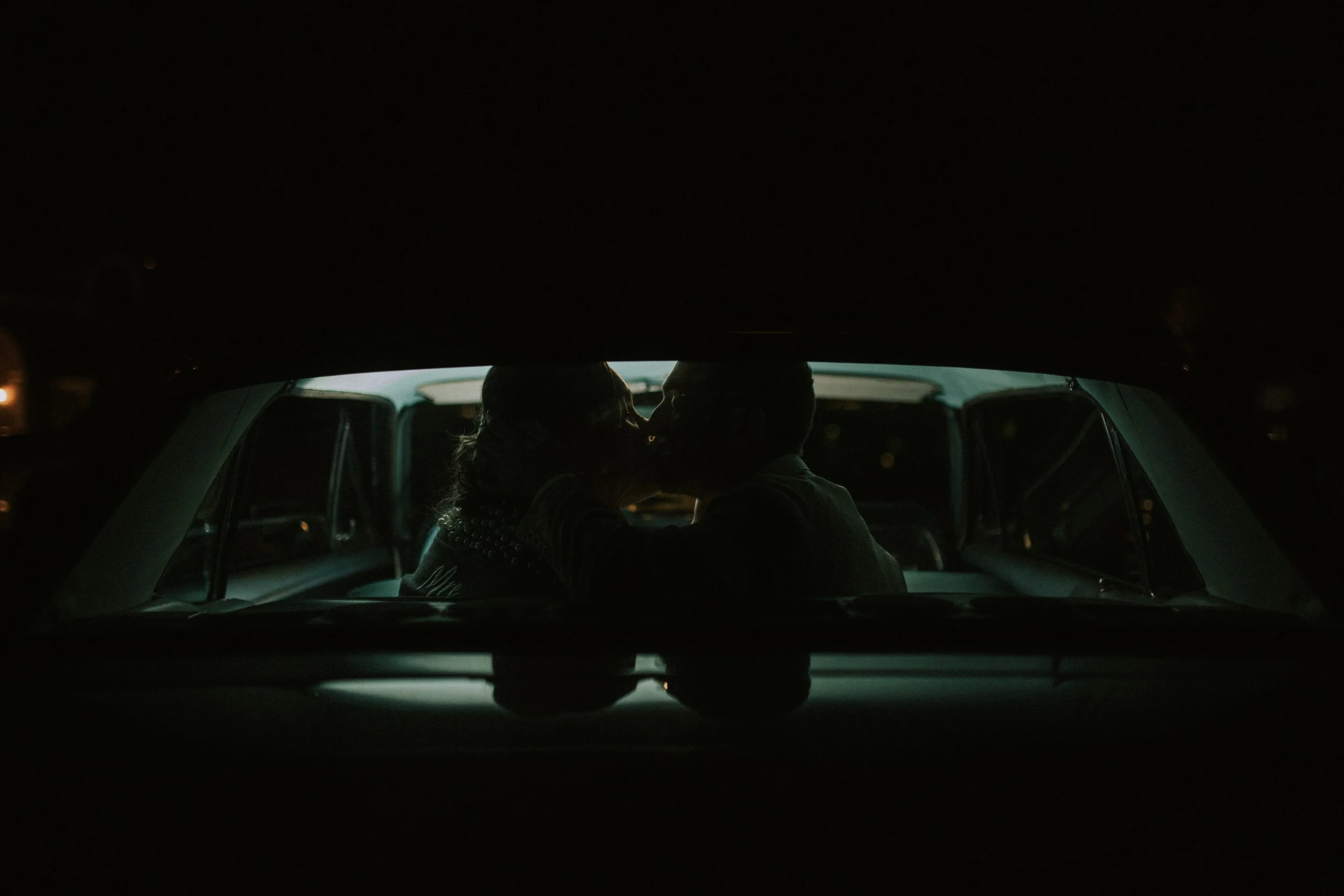 Bride and groom kiss in wedding get away car. Phoenix, Arizona wedding. Canon R5