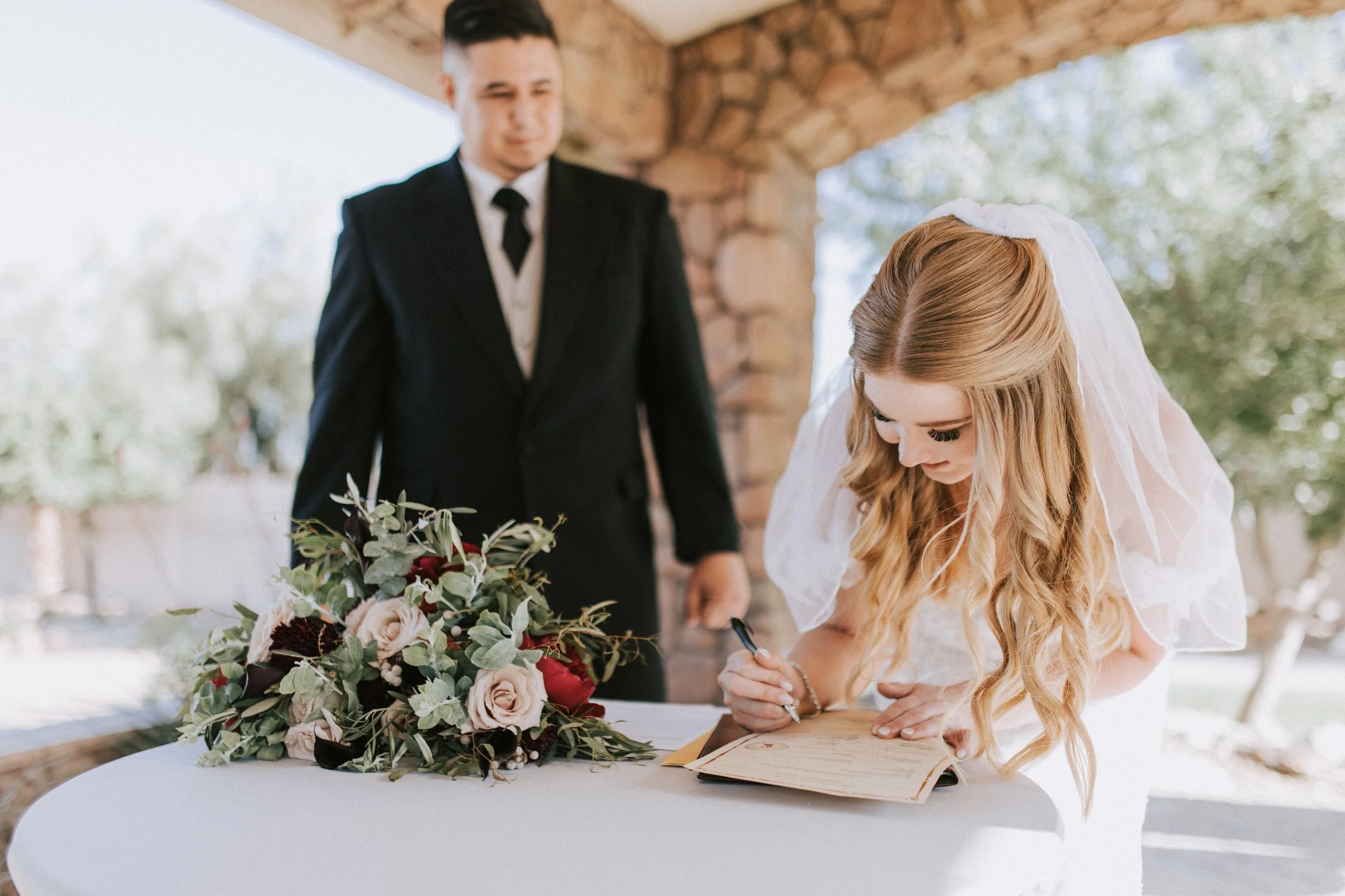 Bride and groom sign marriage license at their wedding. Superstition Manor. Mesa Arizona wedding. Canon R5.