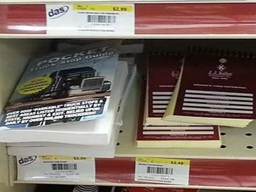 Shelf with truck stop guidebook and spiral notebooks for sale