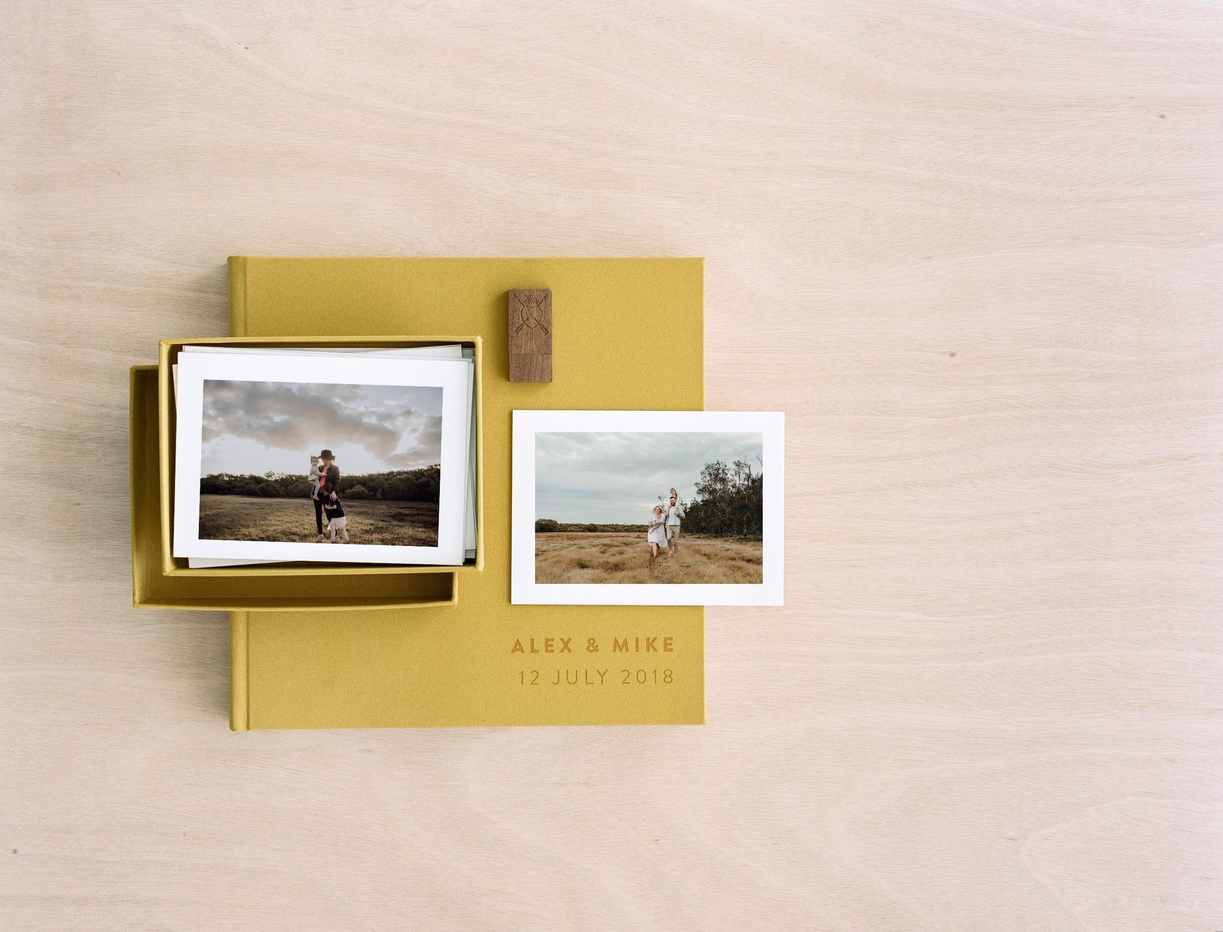  image of yellow fabric album with box of printed photos on top 
