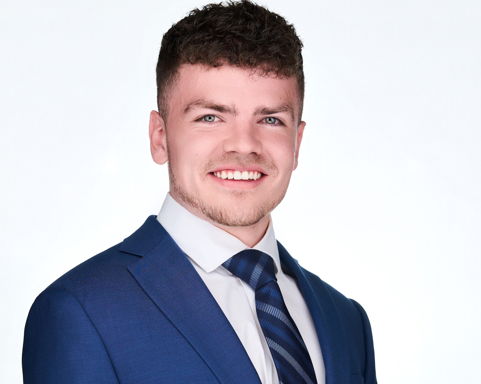 Professional Headshot of man in Brighton Colorado in blue suit with white shirt.