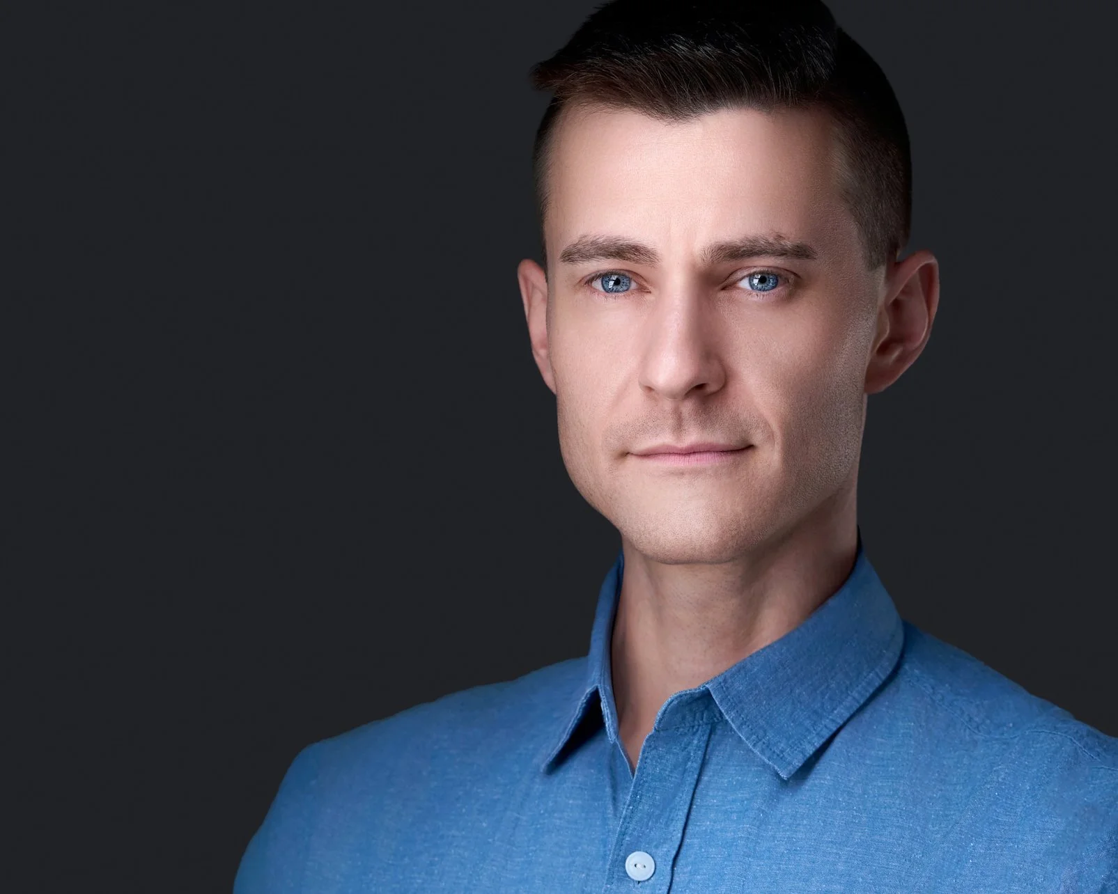 Professional actor headshot of male in blue shirt by Leo Peterson Photography