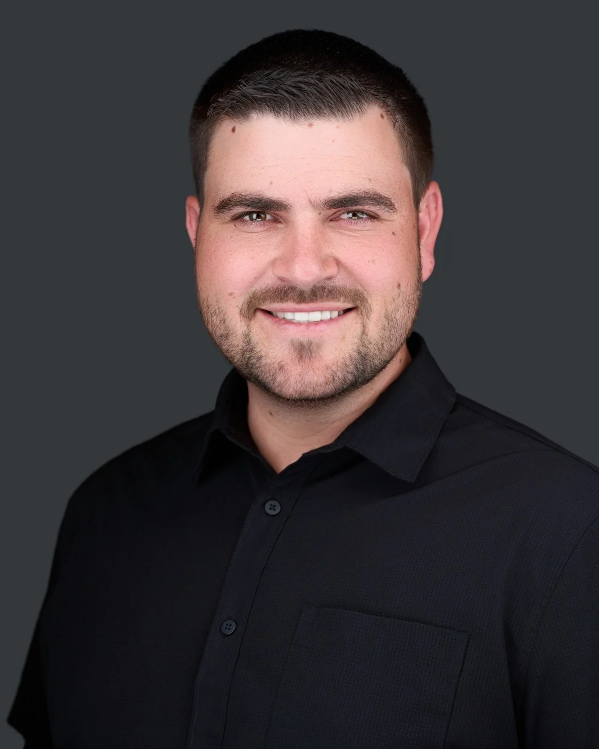 Profession headshot of Man in black polo in Westminster Co