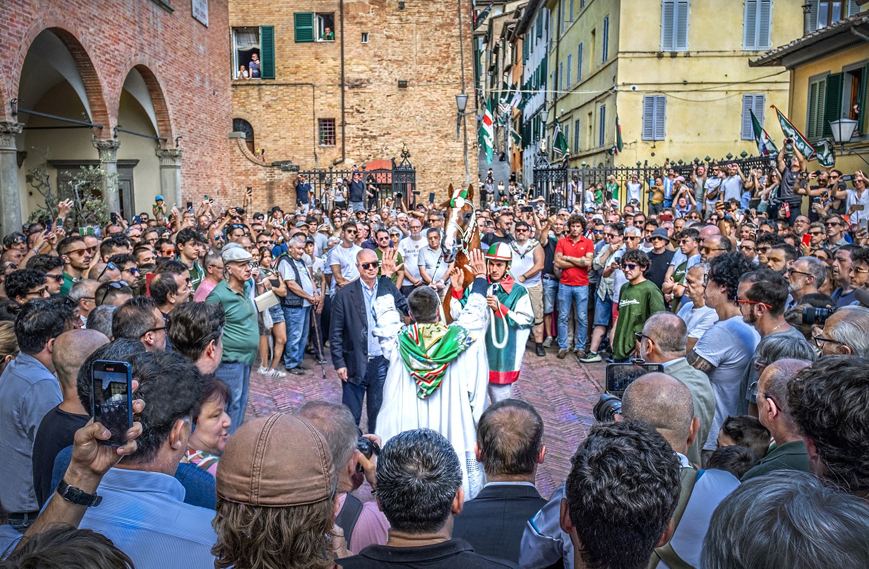 Priest Blessing of horse at the church of the Oca Contrada - morning of the annual Palio horse race - Siena, Italy 2024
