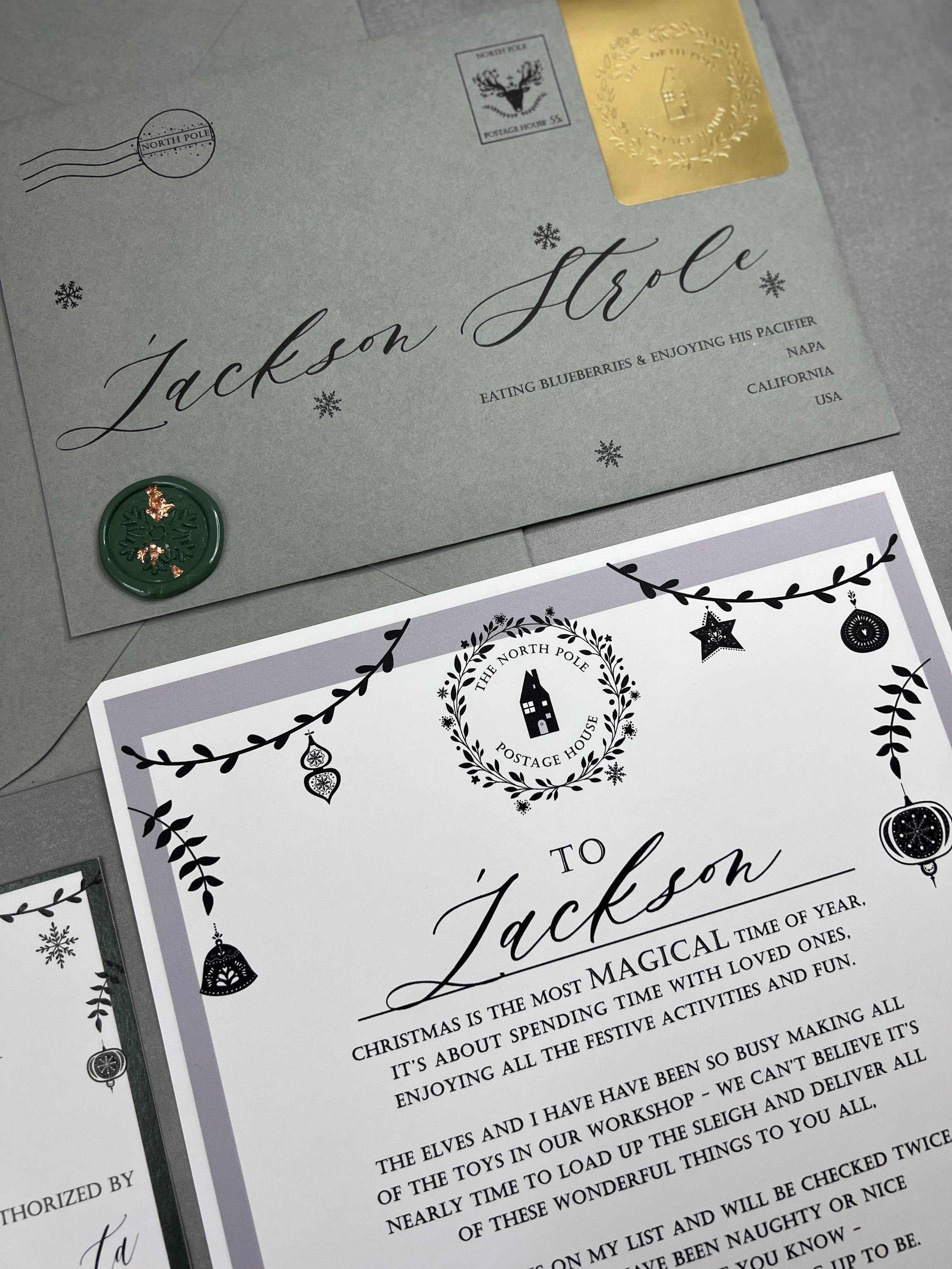 Santa Letter writing Kit. Shows a personalized envelope with embossed sticker. A letter from Santa, a nice list certificate, a Christmas List letter and pre-addressed return envelope.